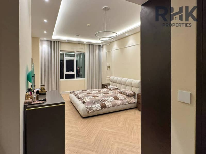4 Master bedroom with king bed, dressing area and city view window in Dubai apartment