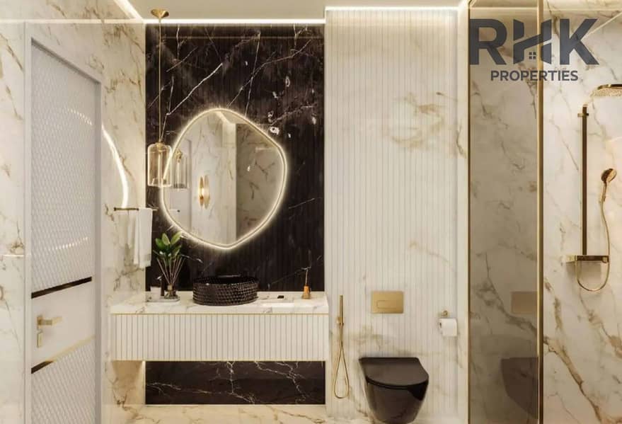 6 Marble en-suite bathroom in Danube Oasis Dubai apartment with gold fixtures and walk-in shower