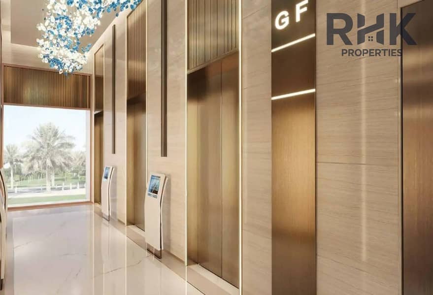 14 Ground floor lift lobby at Danube Oasis Dubai with wood panelling and smart directory screens