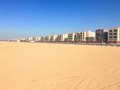 Plot in Vendita a Al Alia, Ajman - A_large_empty_residential_plot_in_the_UAE_situated_one_block_from_a_road. _The_scene_features_an_expansive_flat_sandy_terrain_without_trees_or_signs_providing_an_open_unobstructed_view. _The_sky_is_bright_blue_typical_. jpeg Plot in Vendita a Al Alia, Ajman - A_large_empty_residential_plot_in_the_UAE_situated_one_block_from_a_road. _The_scene_features_an_expansive_flat_sandy_terrain_without_trees_or_signs_providing_an_open_unobstructed_view. _The_sky_is_bright_blue_typical_. jpeg