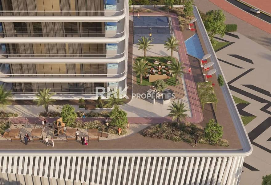 2 Aerial view of residential building podium amenities with tennis court, swimming pool, jogging track, and landscaped gardens in Dubai