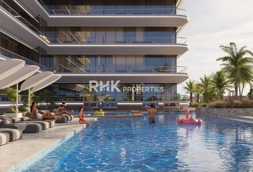 3 Resort-style swimming pool with sun loungers and curved balconies at luxury residential development in Dubai
