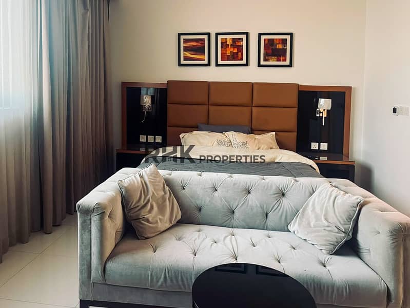 2 Hotel-style furnished bedroom with velvet sofa and upholstered headboard Dubai rental