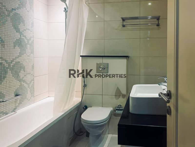 10 Bathroom with bathtub and mosaic tiles in furnished apartment Dubai Silicon Oasis