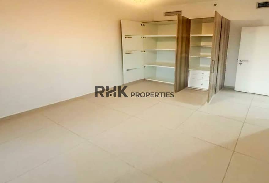 3 Spacious bedroom with built-in wardrobe and fitted shelving in Dubai apartment