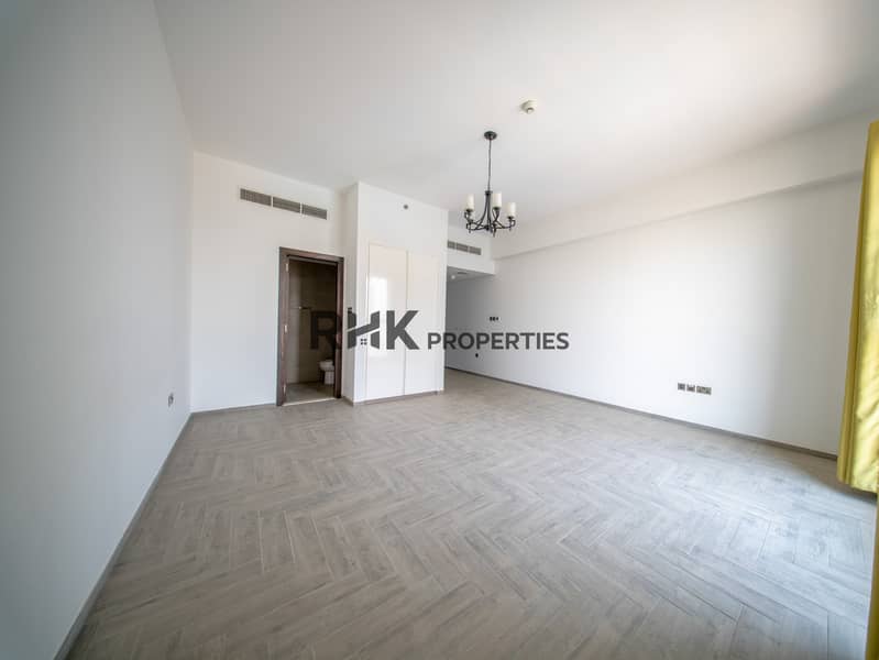 3 Large unfurnished studio apartment with open layout, built-in storage and floor-to-ceiling window