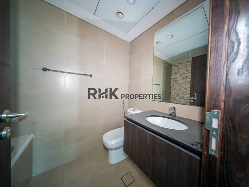 4 Modern apartment bathroom with vanity sink, large mirror and contemporary tile finishes