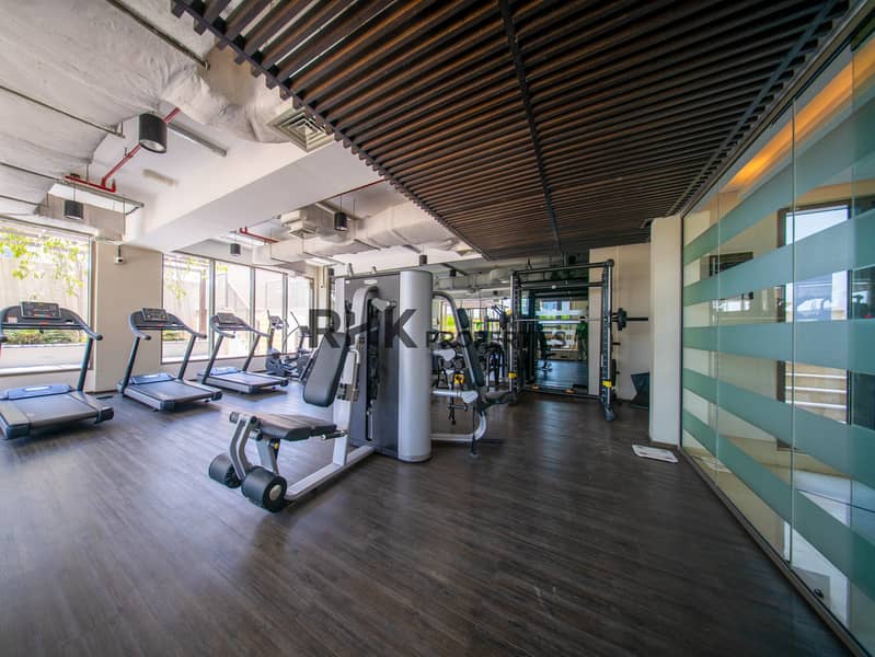 6 Fully equipped residential gym with cardio machines, strength equipment and modern workout space