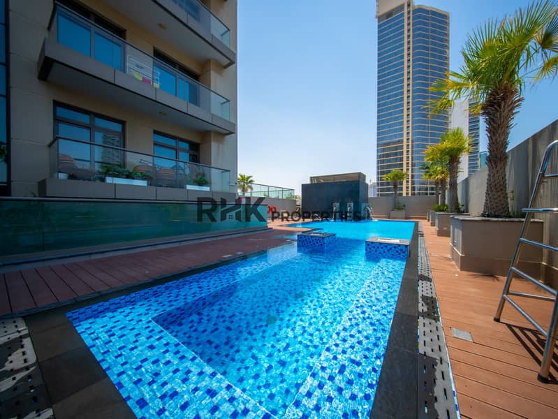10 Luxury residential pool area surrounded by modern apartments and landscaped outdoor spaces
