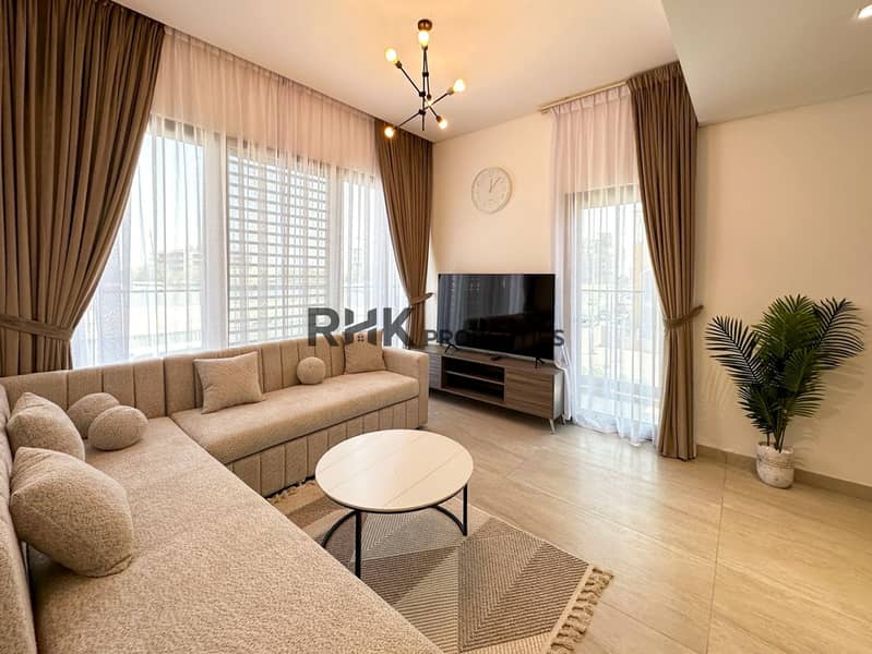 Furnished living room with L-shaped sofa, marble coffee table, and floor-to-ceiling windows in JVC Dubai Furnished living room with L-shaped sofa, marble coffee table, and floor-to-ceiling windows in JVC Dubai