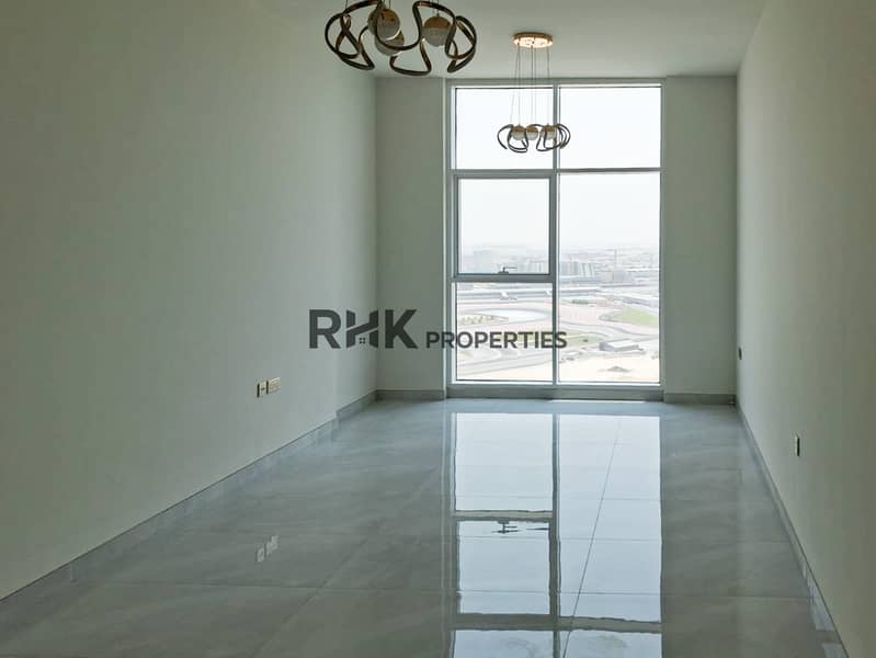2 Bright unfurnished living room with panoramic racing circuit view in Dubai high-rise apartment