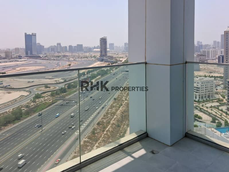 10 Open balcony with glass railing overlooking Dubai Autodrome and Sheikh Mohammed Bin Zayed Road