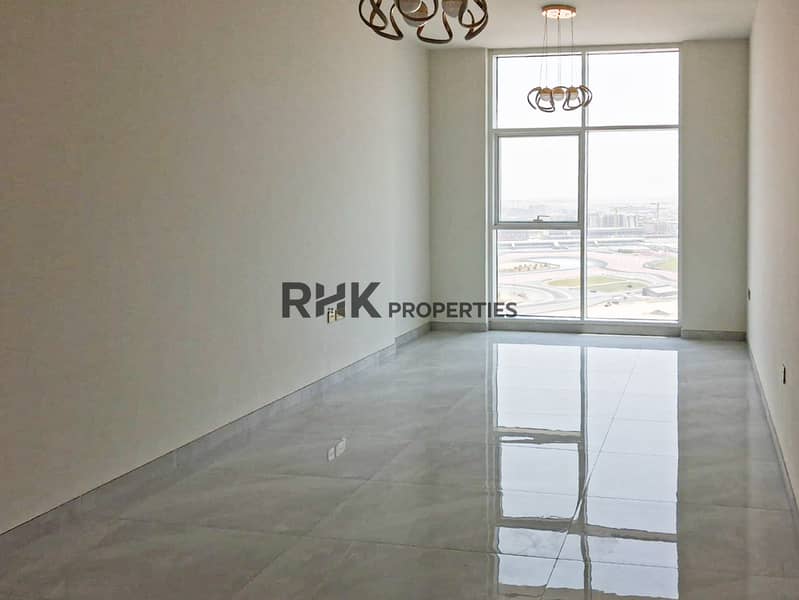 Unfurnished living room with high ceilings and racetrack view in Dubai Silicon Oasis apartment Unfurnished living room with high ceilings and racetrack view in Dubai Silicon Oasis apartment