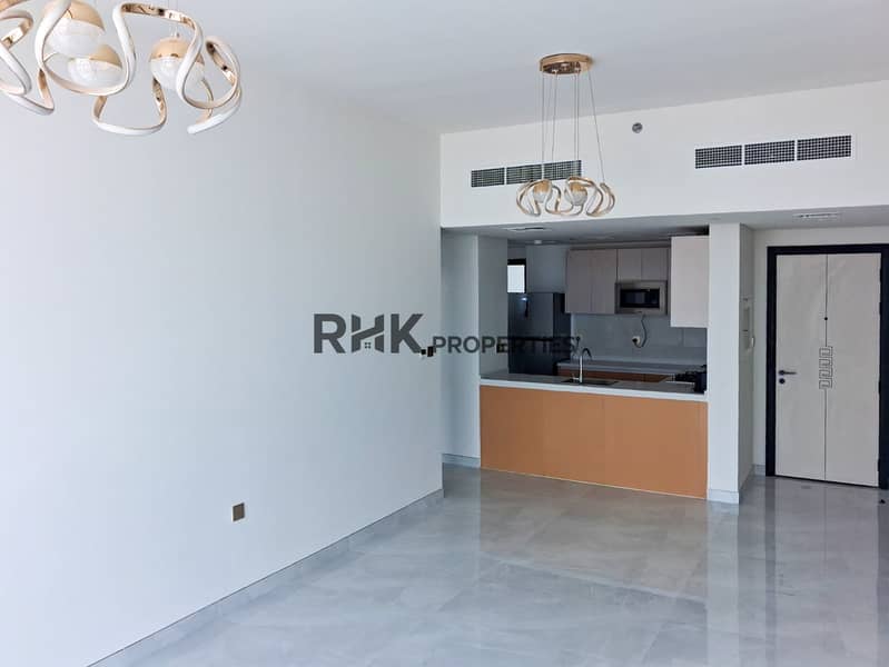 9 Spacious living room with open-kitchen layout, designer chandeliers and central AC in Dubai flat