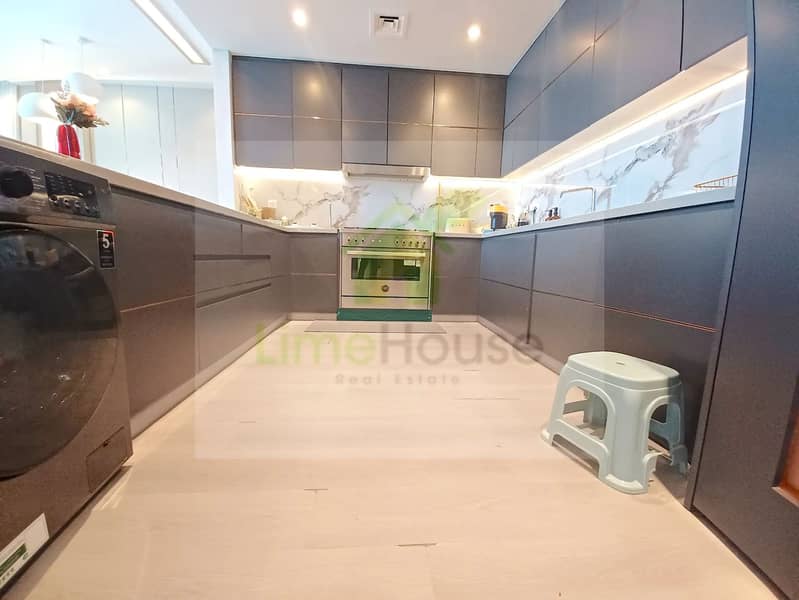 9 3-bedroom-apartment-5242-dubai-marina-kitchen-u-shaped-integrated-washer-marble-backsplash. webp