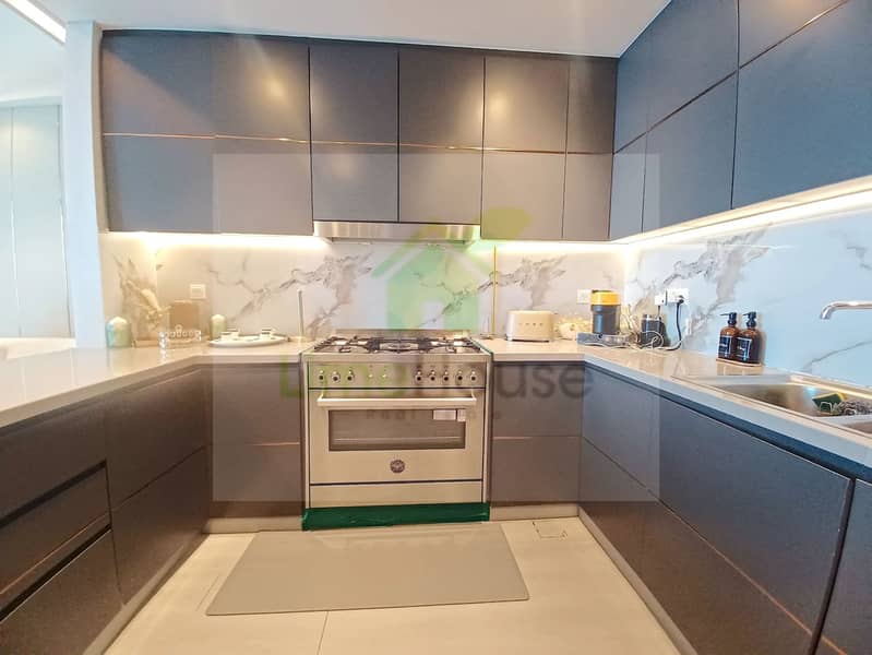 28 3-bedroom-apartment-5242-dubai-marina-kitchen-modern-cabinets-marble-backsplash. webp