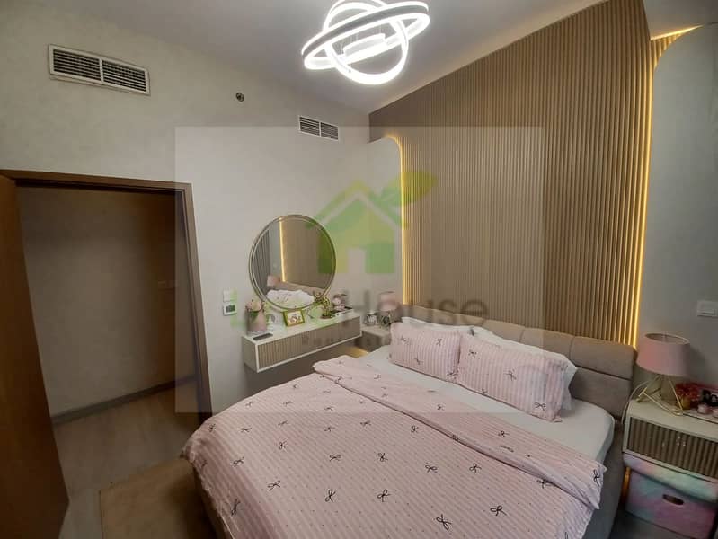 32 dubai-marina-bedroom-modern-chandelier-wood-panel-floating-vanity-round-mirror. webp
