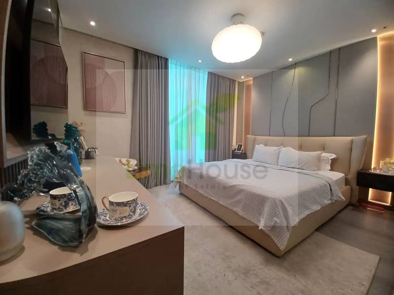 33 dubai-marina-master-bedroom-upholstered-bed-modern-lighting-feature-wall. webp