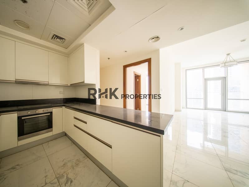 6 Semi-open kitchen with built-in oven, black granite counters and marble living area in Dubai apartment