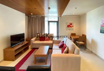 فلیٹ 1 غرفة نوم للايجار في مدينة دبي الرياضية، دبي - Furnished living room with dual beige sofas, TV unit and dining area in Dubai Sports City apartment