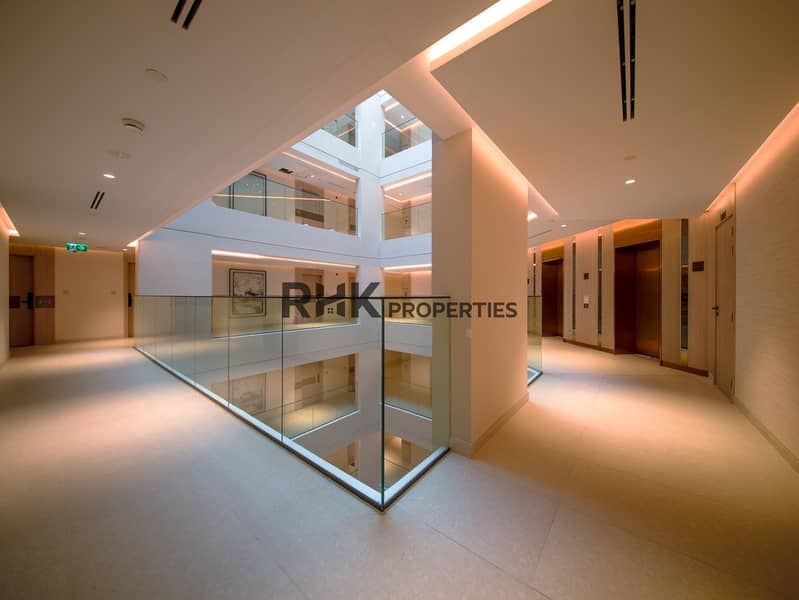 15 Bright hotel-style hallway and atrium walkway in serviced Dubai residential building Primary keyword: serviced Dubai residential building