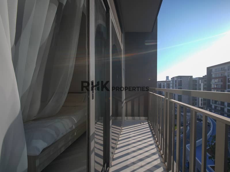 16 Studio apartment balcony with city and community views in Dubai residential tower Primary keyword: apartment balcony Dubai