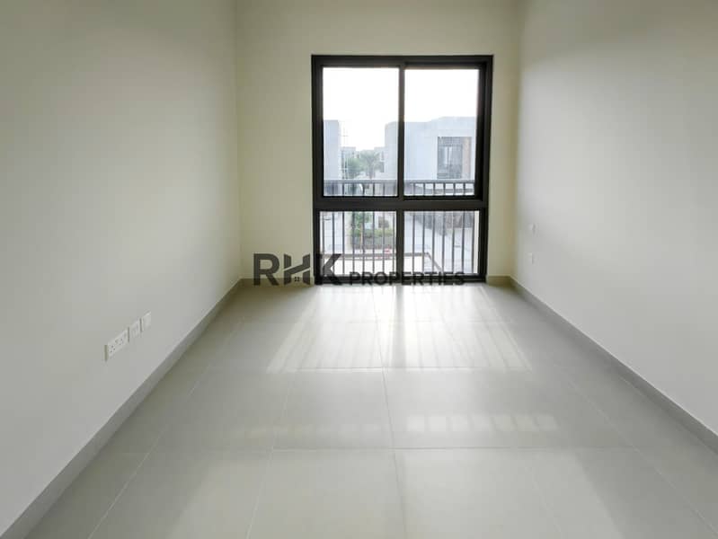 4 Bright bedroom with sliding window balcony overlooking townhouse community in Dubai