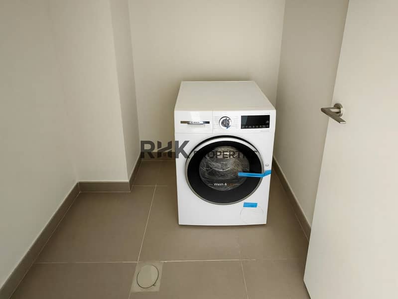 9 Bosch Wash & Dry front-load washing machine in dedicated laundry room of Dubai townhouse