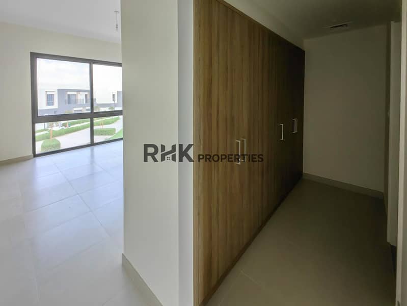 12 Bedroom with built-in floor-to-ceiling wood wardrobe and community park view in Dubai townhouse