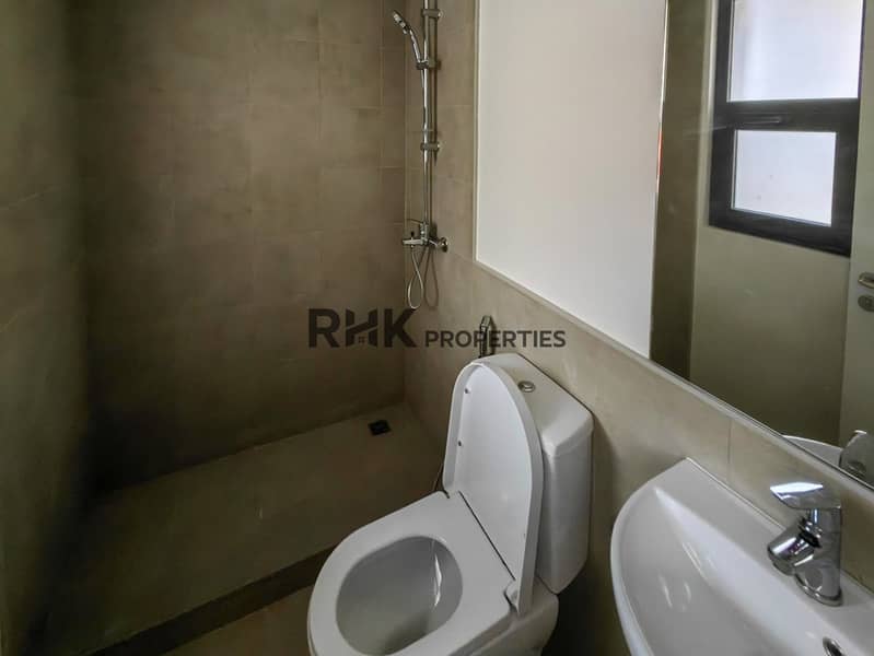 15 Secondary bathroom with shower, toilet and wall-hung basin in Dubai gated community townhouse