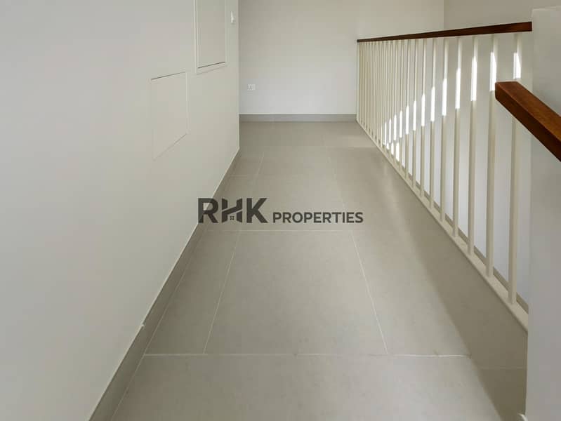 19 Upper floor hallway with white balustrade railing and tiled flooring in Dubai townhouse