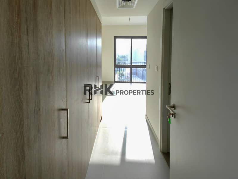 27 Sunlit bedroom with full-height wood fitted wardrobe and balcony window in new Dubai townhouse
