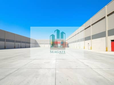 Industrial Land for Rent in Al Sajaa, Sharjah - An_industrial_yard_in_the_UAE_with_a_low_wall_surrounding_a_large_flat_concrete_floor. _The_scene_features_several_shipping_containers_stacked_neatly_within_the_spacious_yard. _The_wall_is_not_very_high_allowing_for_. jpeg Industrial Land for Rent in Al Sajaa, Sharjah - An_industrial_yard_in_the_UAE_with_a_low_wall_surrounding_a_large_flat_concrete_floor. _The_scene_features_several_shipping_containers_stacked_neatly_within_the_spacious_yard. _The_wall_is_not_very_high_allowing_for_. jpeg