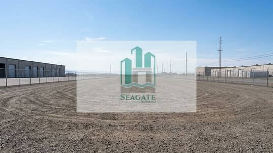 Plot de à à vendre à Emirates Industrial City, Sharjah - A_very_large_empty_industrial_photo_landscape_in_wide_angle_perspective_a_clean_vacant_industrial_yard_with_a_wide_dirt_gravel_ground_distant_warehouse_buildings_on_the_left_and_right_a_tall_chain_link_fence_enclosing. png Plot de à à vendre à Emirates Industrial City, Sharjah - A_very_large_empty_industrial_photo_landscape_in_wide_angle_perspective_a_clean_vacant_industrial_yard_with_a_wide_dirt_gravel_ground_distant_warehouse_buildings_on_the_left_and_right_a_tall_chain_link_fence_enclosing. png
