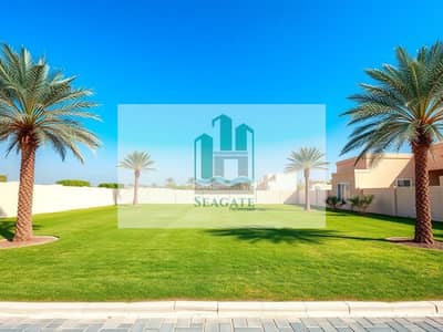 Plot para en Venta en Al Helio, Ajman - An_empty_freehold_villa_plot_in_the_UAE_showcasing_a_clear_and_open_area_of_land_ready_for_development. _The_plot_should_have_a_flat_surface_with_well_maintained_grass_surrounded_by_a_few_palm_trees_and_minimal_landsc. jpeg