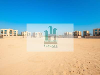 ارض استخدام متعدد  للبيع في الروضة، عجمان - A_large_empty_residential_plot_in_the_UAE_situated_one_block_from_a_road. _The_scene_features_an_expansive_flat_sandy_terrain_without_trees_or_signs_creating_an_open_unobstructed_view. _The_sky_is_bright_blue_typic (3). jpeg