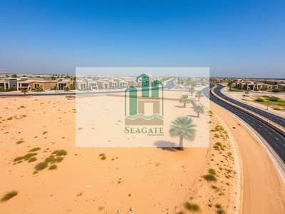 Plot te Koop in Al Helio, Ajman - Aerial_drone_view_of_a_sandy_plot_near_a_roadside_in_the_UAE_surrounded_by_modern_villa_communities. _The_image_showcases_the_golden_sandy_terrain_interspersed_with_patches_of_greenery_and_palm_trees. _The_villas_in_th. jpeg Plot te Koop in Al Helio, Ajman - Aerial_drone_view_of_a_sandy_plot_near_a_roadside_in_the_UAE_surrounded_by_modern_villa_communities. _The_image_showcases_the_golden_sandy_terrain_interspersed_with_patches_of_greenery_and_palm_trees. _The_villas_in_th. jpeg