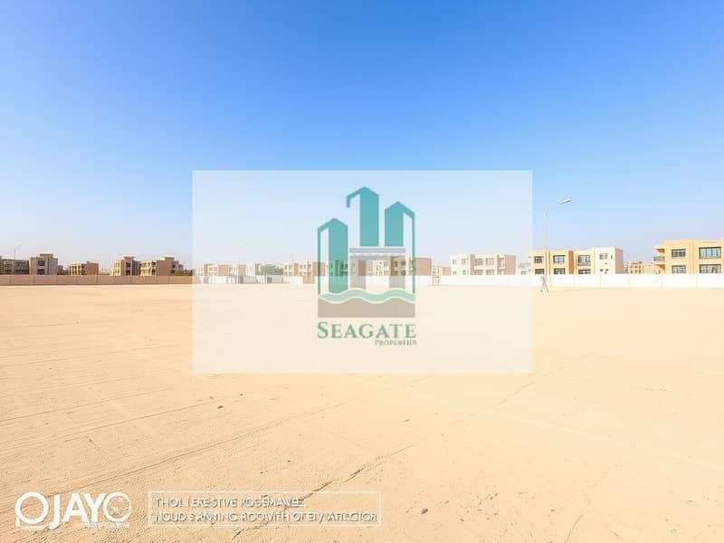 3 A_large_empty_residential_plot_in_the_UAE_situated_one_block_from_a_road. _The_scene_features_an_expansive_flat_sandy_terrain_without_trees_or_signs_creating_an_open_unobstructed_view. _The_sky_is_bright_blue_typic (2). jpeg