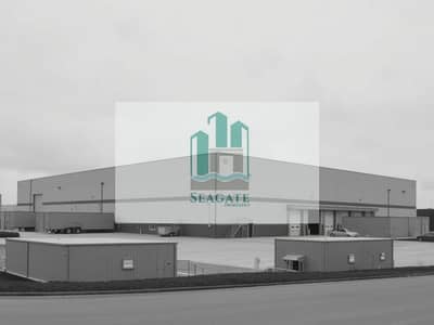 Warehouse for Sale in Al Sajaa Industrial, Sharjah - An_exterior_view_of_a_large_warehouse_in_grayscale. _The_warehouse_has_a_simple_industrial_design_with_large_loading_docks_and_a_plain_facade. _Surrounding_the_warehouse_are_small_service_buildings_in_shades_of_gray. _T. jpeg