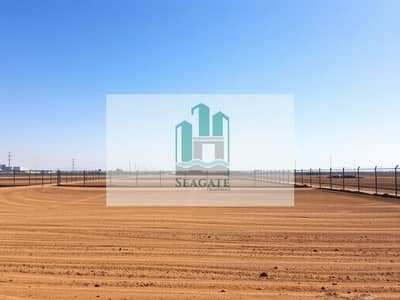 ارض استخدام متعدد للبيع في الحمرية، الشارقة - A_serene_empty_industrial_plot_featuring_bare_land_with_a_clear_blue_sky_above. _The_plot_is_surrounded_by_a_simple_fence_with_no_buildings_or_machinery_present. _The_ground_is_flat_and_covered_in_brown_earth_suggestin. jpeg ارض استخدام متعدد للبيع في الحمرية، الشارقة - A_serene_empty_industrial_plot_featuring_bare_land_with_a_clear_blue_sky_above. _The_plot_is_surrounded_by_a_simple_fence_with_no_buildings_or_machinery_present. _The_ground_is_flat_and_covered_in_brown_earth_suggestin. jpeg