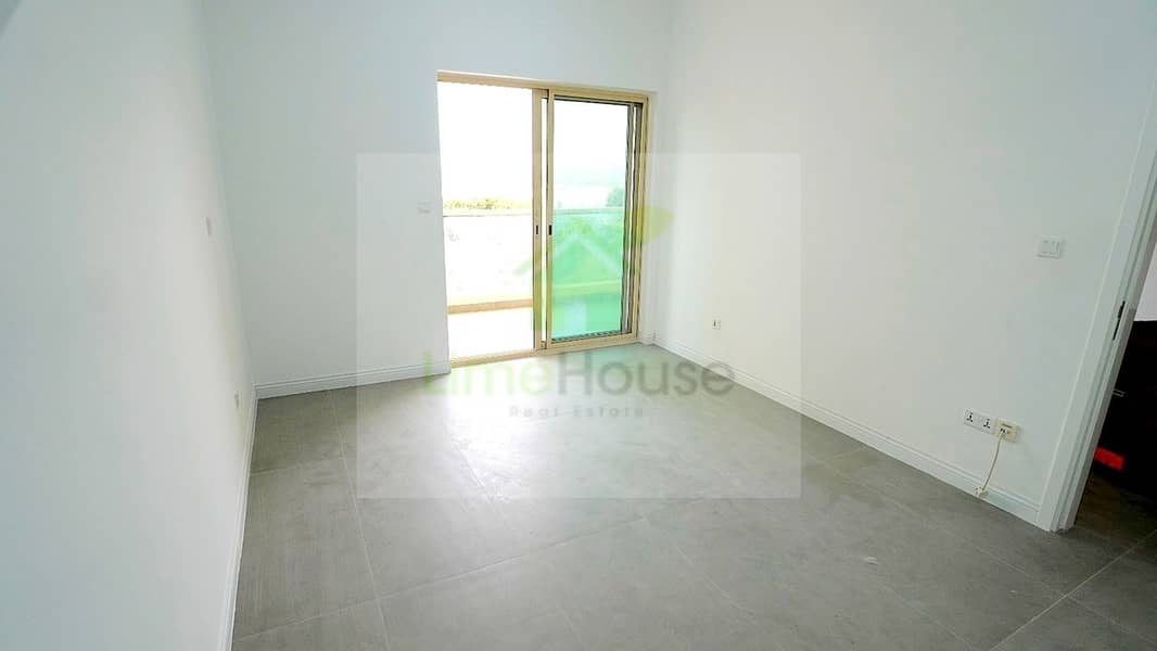4 07-al-arta-4-greens-dubai-living-room-sliding-door-balcony-1br-apartment-rent. jpg
