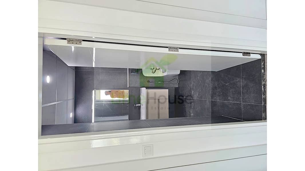 7 21-al-arta-4-greens-dubai-bathroom-charcoal-tiles-vanity-mirror-1br-apartment-rent. jpg