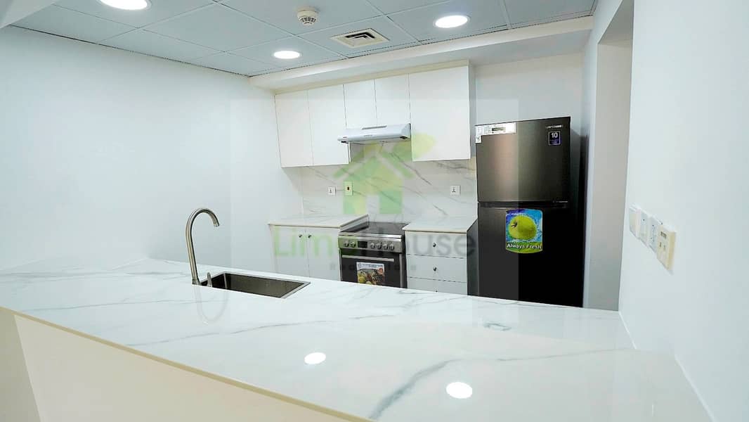 10 13-al-arta-4-greens-dubai-kitchen-white-cabinets-stainless-steel-appliances-1br-apartment-rent. jpg