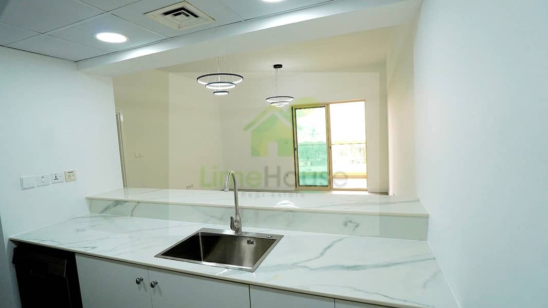 11 14-al-arta-4-greens-dubai-kitchen-marble-counter-pendant-lights-1br-apartment-rent. jpg