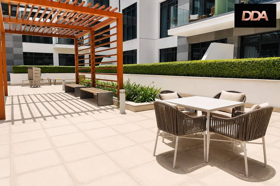 13 azizi-greenfield-1-bedroom-apartment-courtyard-seating-area. png