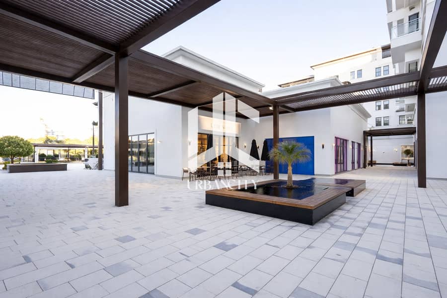 2 Modern Mediterranean shopping plaza at sunset. png