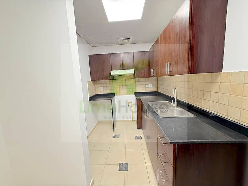 5 seasons-community-jvc-townhouse-closed-kitchen-dark-wood-cabinetry. jpg