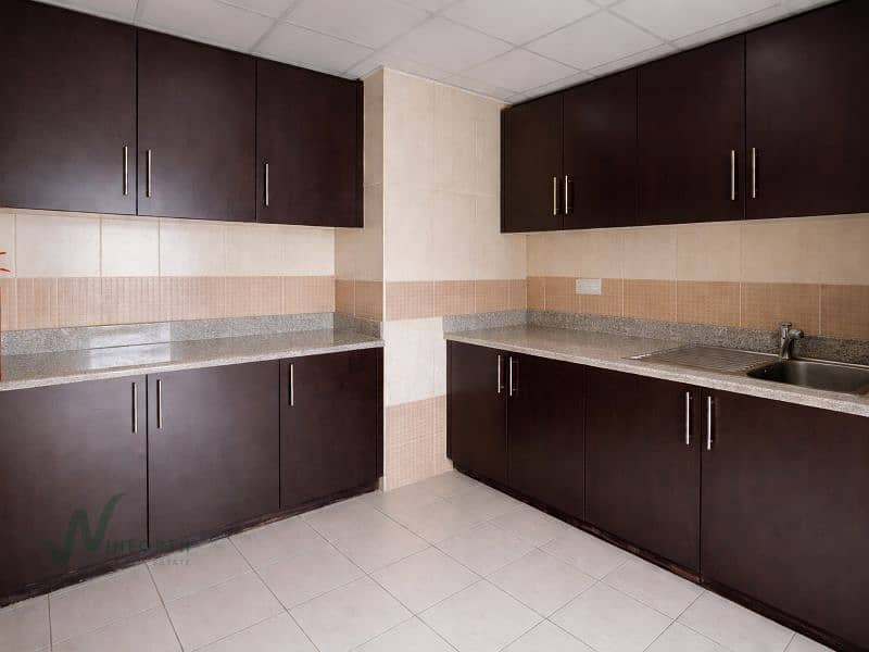 12 Modern kitchen with dark wood cabinetry. png