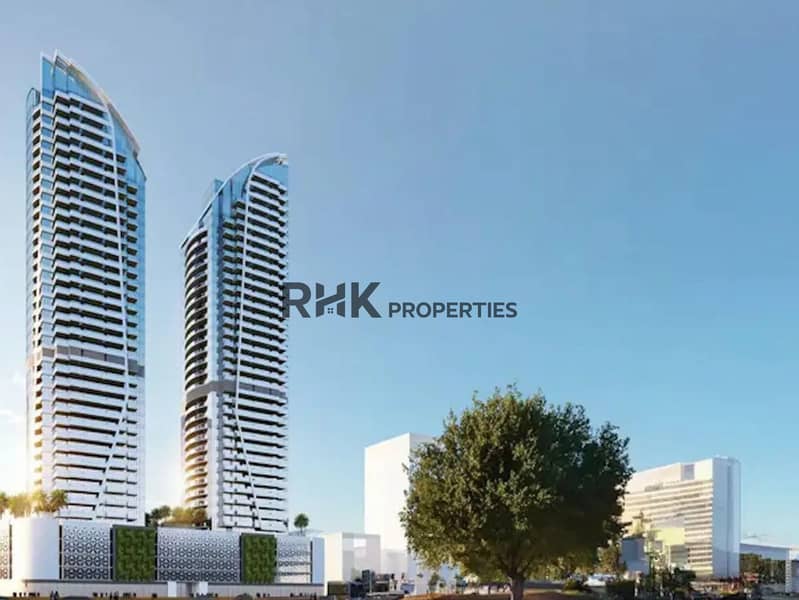 2 Red Square Dubai twin residential towers with curved glazed facades, green podium and arabesque base detailing