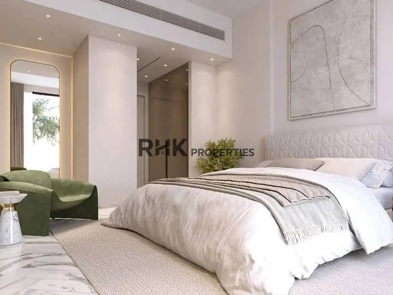 4 Luxury master bedroom with upholstered headboard, green velvet armchair and marble floors in Red Square Dubai